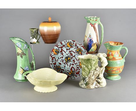 A collection of art deco ceramics, including a Wedgwood jar and cover, various art deco moulded jugs, a Poole platter and oth