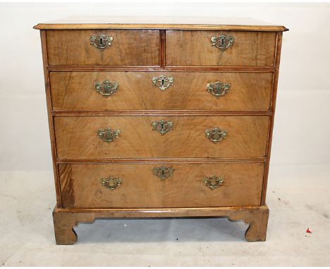 A George III walnut veneered chest of drawers, flat fronted, two short over three long with brass handles, on bracket feet, 7