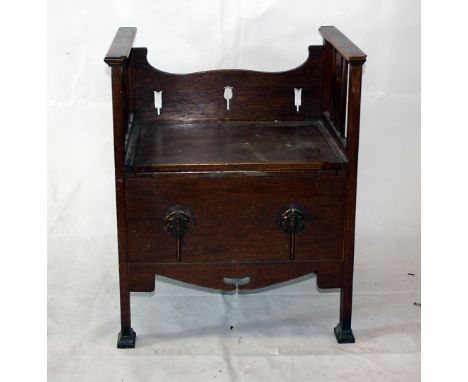 An Arts and Crafts commode seat, with brass inserts to the front, with plastic potty, 55 cm wide x 45 cm deep x 66 cm highLar