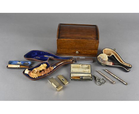A collection of early 20th Century smoking related memorabilia, including a carved meerschaum and amber stemmed cheroot holde