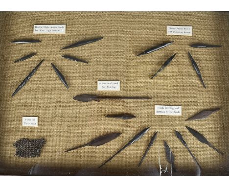 A display of various arrow heads, to include chain mail piercing, armour piercing, hunting and fishing, in glazed display cas