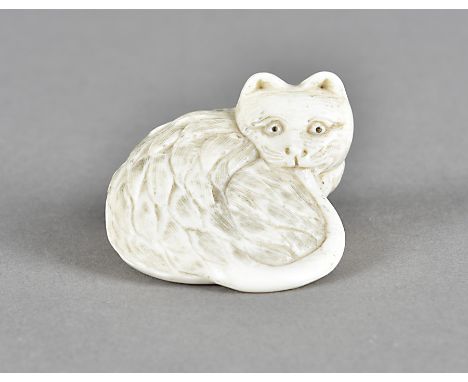 A Meiji period Japanese ivory netsuke, carved as a seated cat biting its own tail, 3.5 cm x 2.5 cm high 