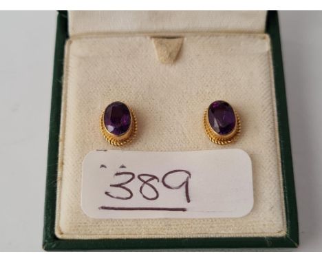 A pair of amethyst earrings in 9ct - boxed 