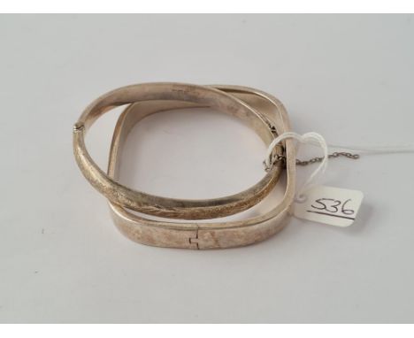 A silver square design bangle plus a silver circular bangle