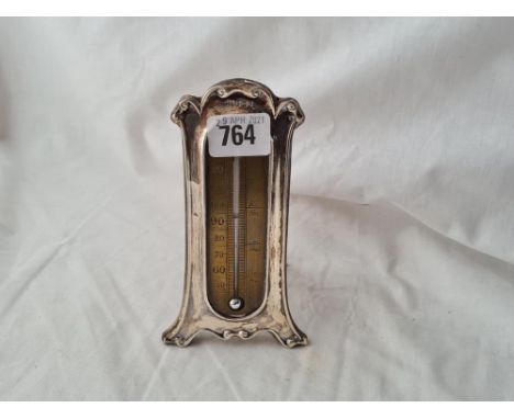 A Edwardian thermometer with glass dial silver surround 6 inches high B'ham 1909 
