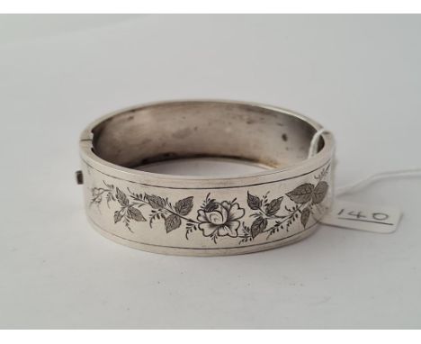 A Victorian silver hinged bangle engraved with roses