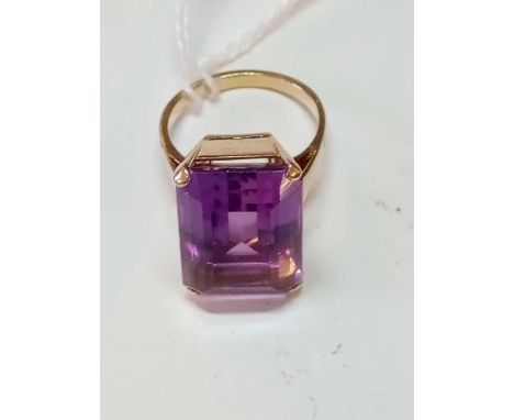 A rectangular amethyst ring set in gold size N - 7.8gms - stone is 19mm x 13mm - boxed