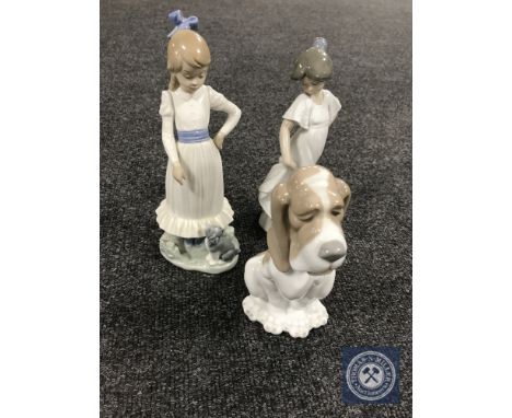 Three Nao figures of two girls and a basset hound 
