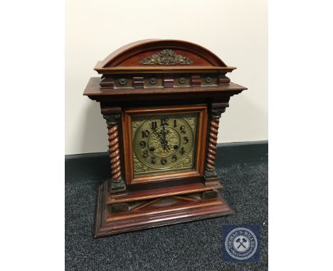 A mahogany arch top bracket clock with brass dial