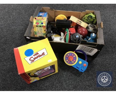 A box of a collection of novelty radios, Adam &amp; Eve radio and a boxed Simpson's talking radio alarm clock 