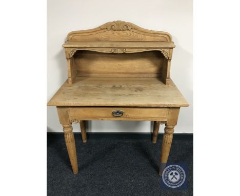 An early 20th century oak writing table with shelf fitted a drawer 