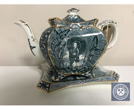 A 19th century English porcelain teapot on stand 