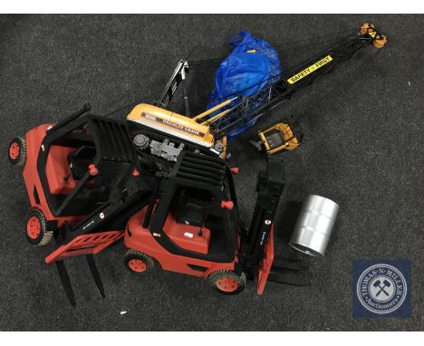 A remote control Caterpillar crane and two remote controlled fork lift trucks 