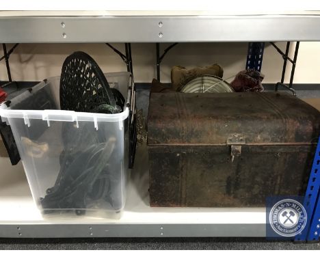 A flat packed cast metal patio table and two chairs with a vintage tin trunk and a fishing rod. (Q) 