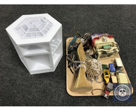 A basket of jewellery stand, trinkets, boxed and unboxed die cast vehicles, etc. 