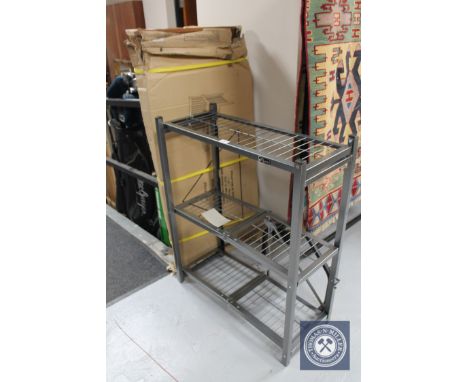 A boxed flat pack wooden garden bench and set of folding metal shelves 