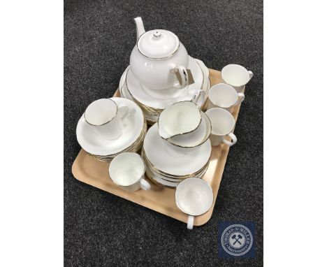 A tray of clock under shade, brass ornaments, decanter, Wedgwood vase and six Tuscan coffee cans and saucers 