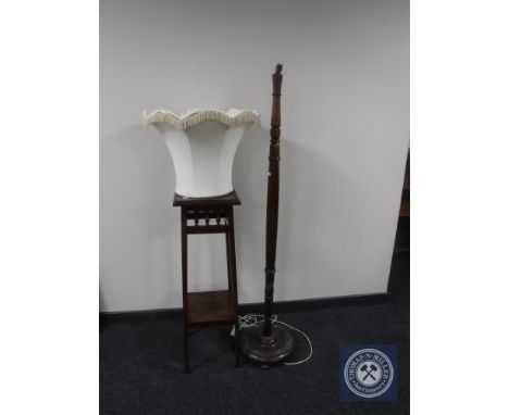 An early twentieth century mahogany plant stand together with standard lamp and shade 