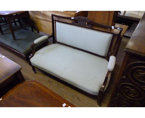 A late 19th/early 20th Century mahogany framed sofa, with carved show wood frame, upholstered in pale blue fabric.