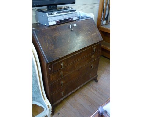 A Georgian style oak bureau, the fall front enclosing fitted interior, above four drawers and bracket feet.
