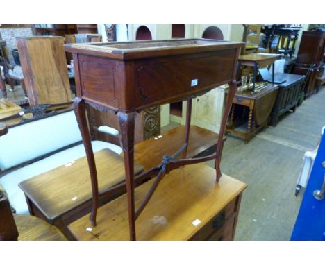 An Edwardian lead lined mahogany planter on swept legs.