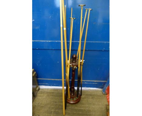 A modern snooker cue stand together with cues and accessories 