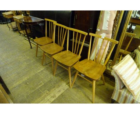 A set of four Ercol stick back kitchen chairs 