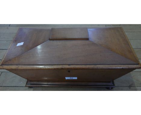A 19th Century mahogany sarcophagus form tea caddy with two section interior.