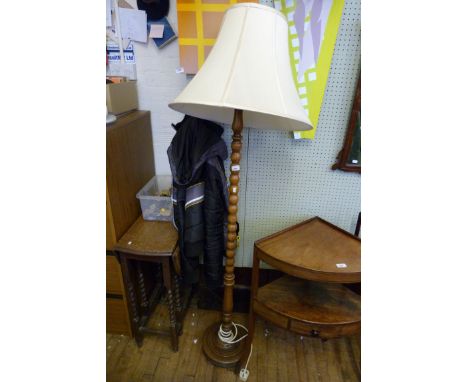 A 20th Century oak bobbin turned standard lamp with shade (sold electrically untested)