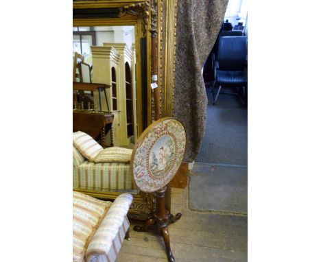 A Victorian tapestry pole screen on tripod base 
