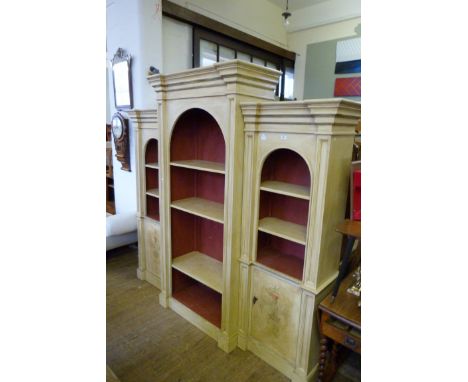 A large three section breakfront bookcase cabinet, with antiqued finish and decorated with scotch thistles.