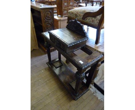 A Victorian Gothic carved oak stick stand, with central drawer.