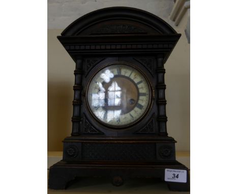 A German fourteen day strike mantel clock in carved case.