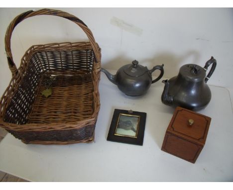 Wicker basket with Victorian and later pewter teapots, a wooden tea caddy, ebonised frame and a selection of various Victoria