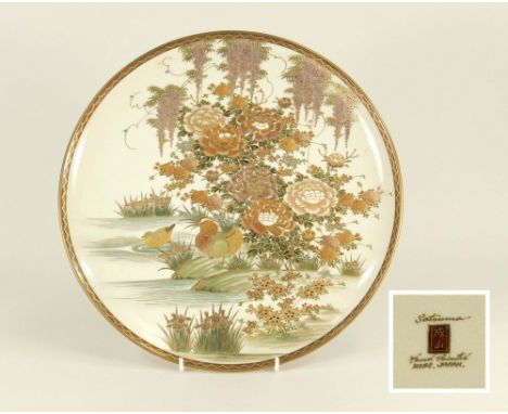 KOBE SATSUMA. A Japanese Satsuma wall plate decorated with exotic waterfowl in a river landscape. Hand painted character mark