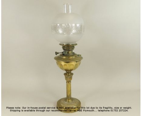 OIL LAMP. A late 19th/early 20th century brass oil lamp with fluted column &amp; etched shade. Height 67cm.