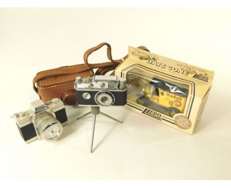 NOVELTIES. A KKW miniature camera table cigarette lighter, a miniature camera 'clock' with case & a Lledo Models of Days Gone