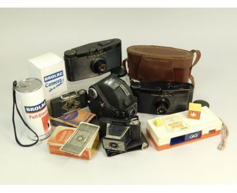 NOVELTY CAMERAS ETC. Seven cameras: Two Purma Special Bakelite cameras, one in original case; two Ensign Midget cameras with 
