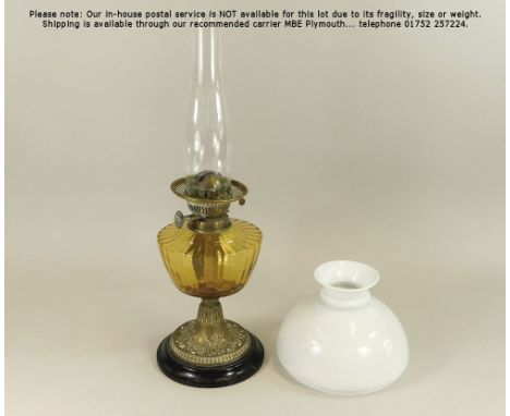 OIL LAMP. A late 19th century brass mounted oil lamp with coloured glass fount. Also, an opaque white glass shade. Height 53c