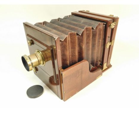 PLATE CAMERA.  A mahogany & brass plate camera with maroon bellows, the body stamped 'R & J Beck London No.610'. Lens unmarke