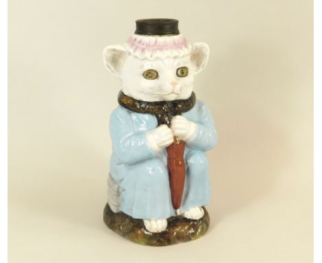 OIL LAMP BASE. A German porcelain oil lamp base, a cat, clothed &amp; with an umbrella. (One original glass eye missing). Hei
