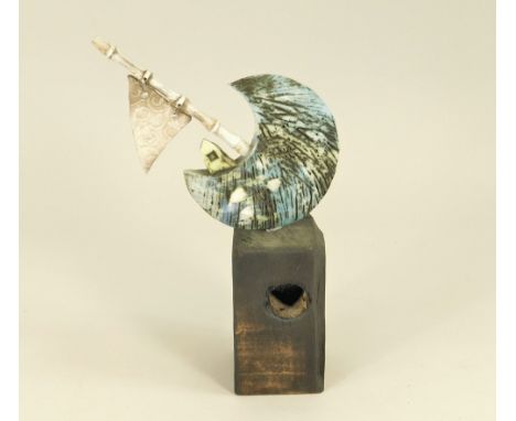 MARK SMITH. A mixed media ceramic &amp; wood sailing boat on a plinth. Unsigned. Height 23cm.