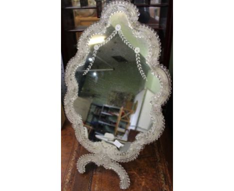 A Venetian dressing table mirror, decoratively framed with easel back. Overall 59cm x 35cm