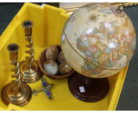 A pair of brass candle sticks a table top globe and a pot of onyx eggs !
