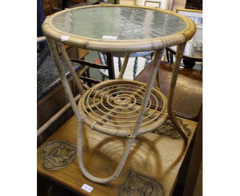 A small circular bamboo table with a glass top