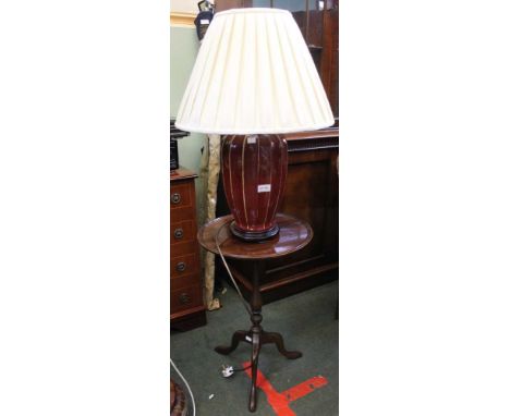 Mahogany saucer top table with a ribbed ceramic lamp and matching shade