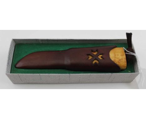 A Helle Tas Norway sheath knife, birch handle, the stitched leather scabbard with retaining strap