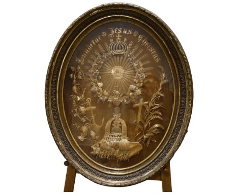 An 18th/19th century large French Reliquary straw-work panel in large gesso oval gilt frame, overall height 103cm Straw-work 