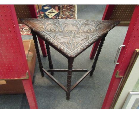 A carved oak square gate-leg table on turned legs 