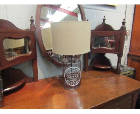 A glass based table lamp advertising Chasey and Ford prize old ale, together with a taupe coloured shade 